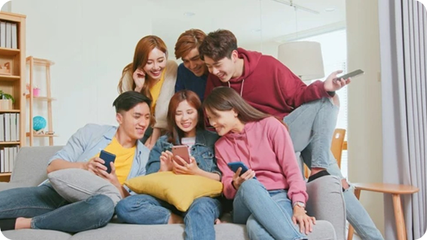 Friends looking at a phone happily